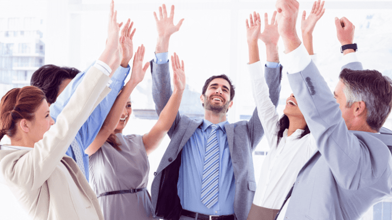 Business people with their hands up with joy