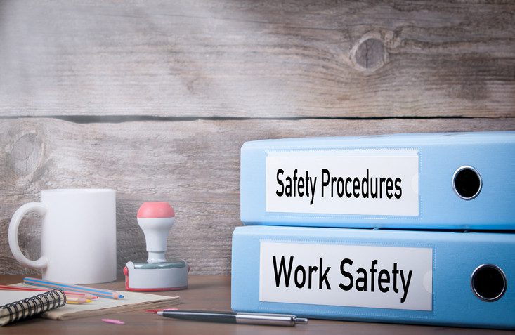 Work Safety and Safety Procedures. Two binders on desk in the office. Business background