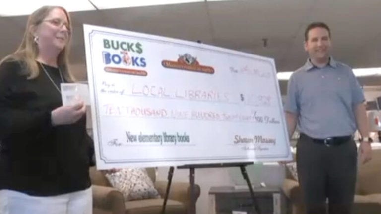 Photo of the check Messey's donated