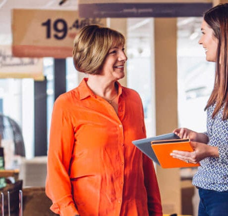 Saleswoman helping someone find what they are looking for