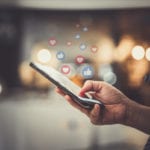 Hand using smartphone with Social media concept.