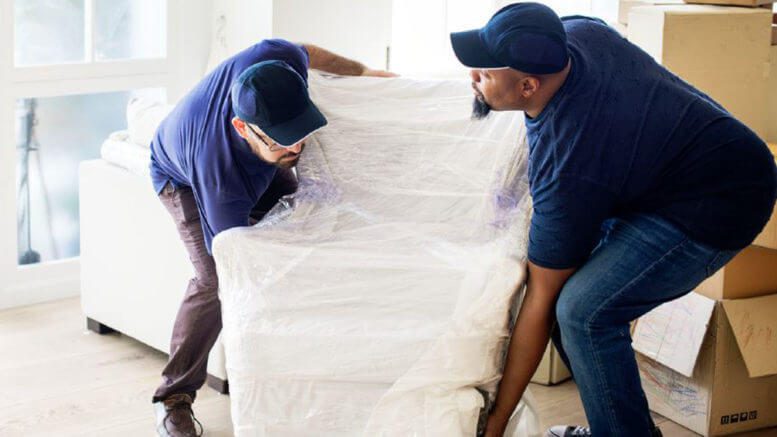 Image of Delivery people setting up furniture