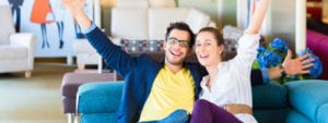 People happy sitting on a sofa