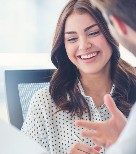 Woman smiling while talking with sales person