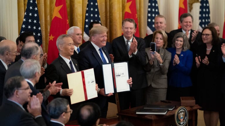 photo shows president trump and others with trade agreement