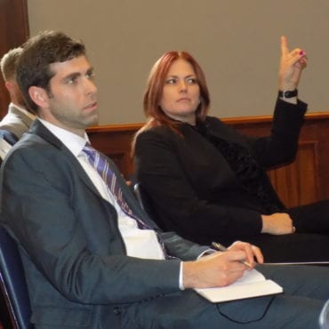 Imagine shows a man and woman in a meeting room