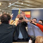 Employees reaching for the HFA Retailer of the Year Award