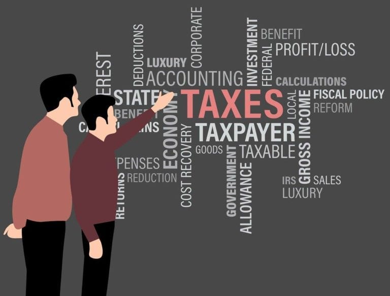 Image shows a graphic of two people are a wall of tax terms