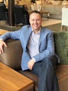 Image shows a man in a furniture store