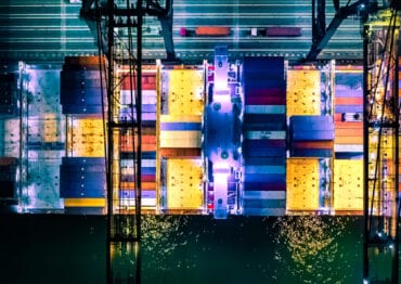 Overhead view of cargo container ship at night