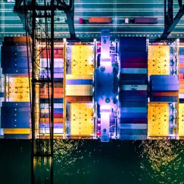 Overhead view of cargo container ship at night