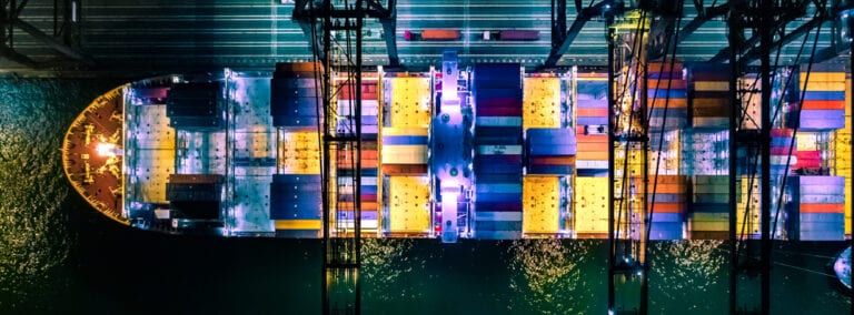 Overhead view of cargo container ship at night