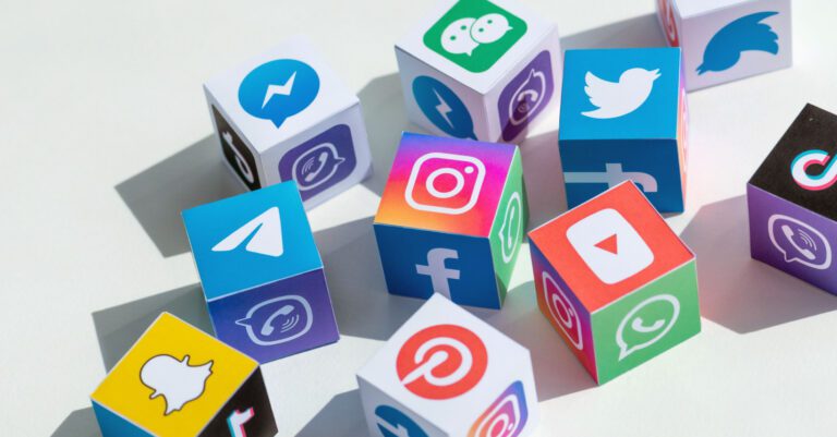 Many cubes on a desk with social media logos on each face of the cubes