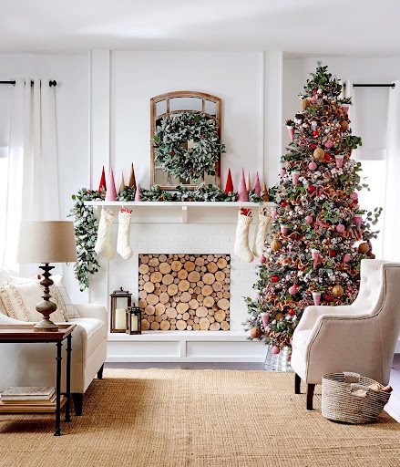 Living room set with fireplace, Christmas Tree and decorated mantel.