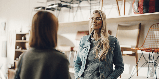 Female customer and female merchant in a furniture store.