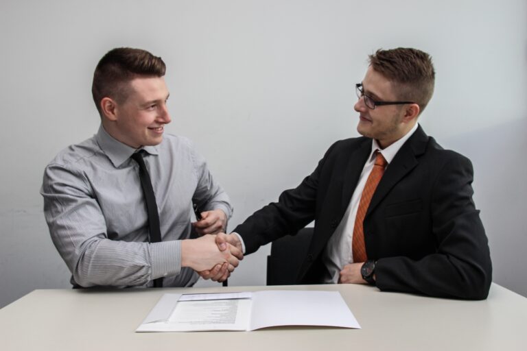 Two men shaking hands over a deal