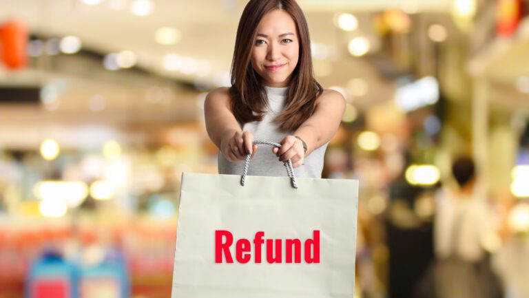 Lady holding a bag in a store for a refund.