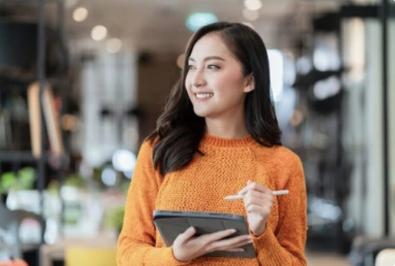 A furniture store employee with clipboard and pencil in hand.