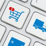 world globe logo on a laptop keyboard, depicts customers order things from retailer sites using internet