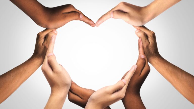 Unity and diversity are at the heart of a diverse group of people connected together as a supportive symbol that represents a sense of and togetherness. Symbol and shape created from hands.