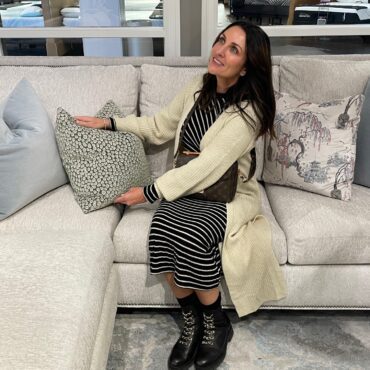 Woman sitting on sofa looking at a pillow