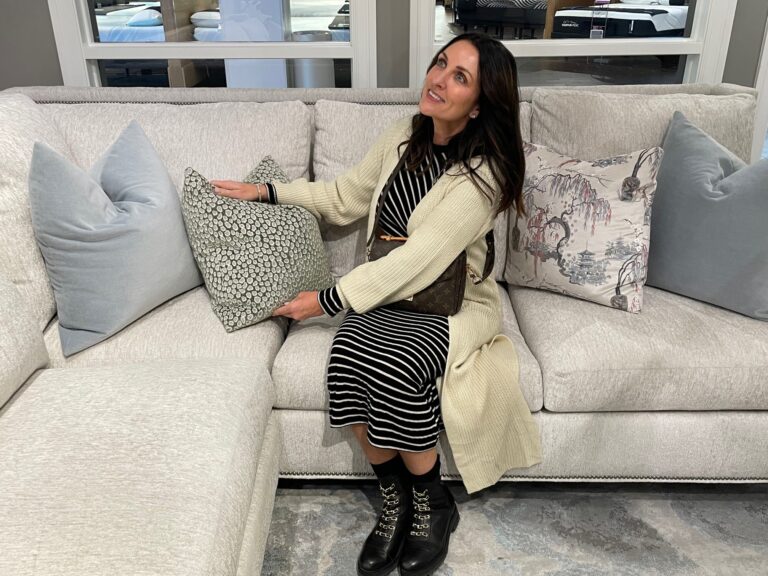 Woman sitting on sofa looking at a pillow