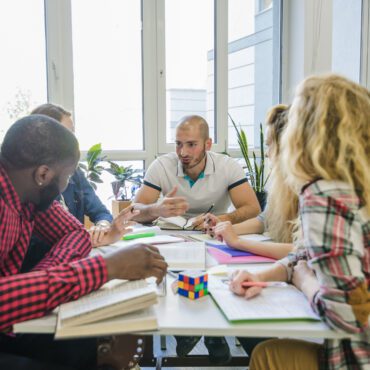 People sitting around a table in an office brainstorming ideas.