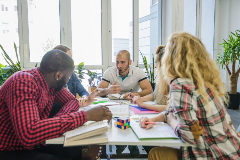 People sitting around a table in an office brainstorming ideas.