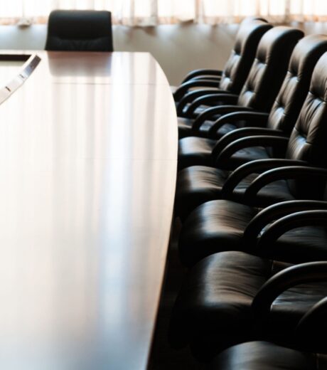 Conference table and chairs in modern meeting room.