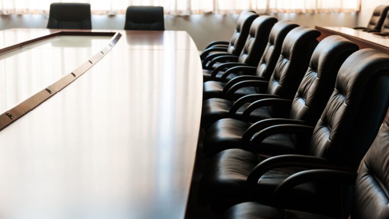 Conference table and chairs in modern meeting room.