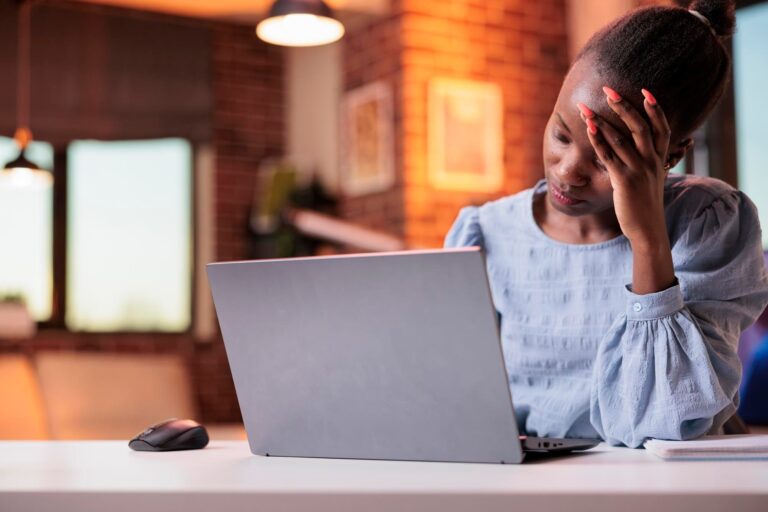 Frustrated consumer sitting in front of a computer.