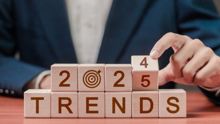 2024 trends concept. Businessman hold wooden block with 2024 change to 2025, marketing monitor, setup objective target business cost and budget planning for new year.