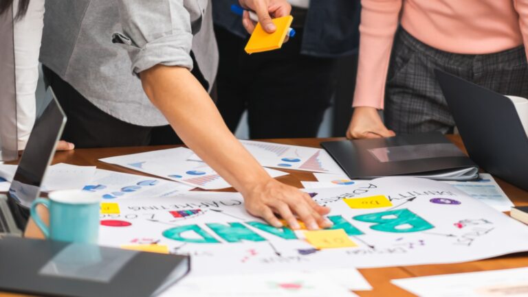 A creative team work together in business brand design project brainstorm meeting. Modern office, colleague coworker, marketing advertisement research or people teamwork concept.