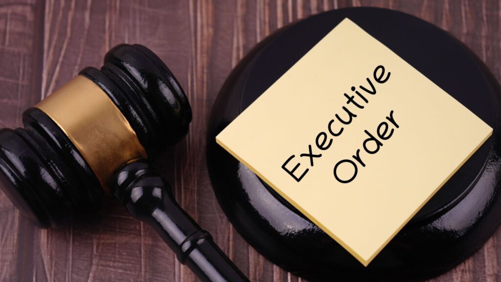 Work and management concept. EXECUTIVE ORDER written on adhesive paper. Blurred styled background.