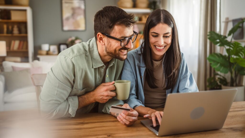 Boyfriend husband and girlfriend wife buy online on laptop with credit card at home