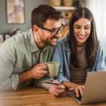 Boyfriend husband and girlfriend wife buy online on laptop with credit card at home