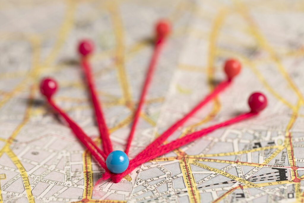 Pushpins with string on a bigger map. Image created by Freepik.com