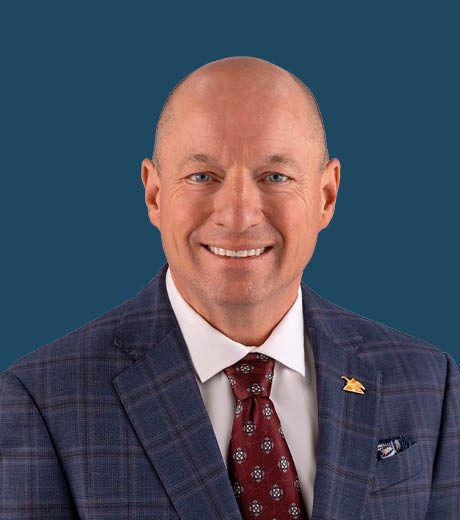 Headshot of Todd Wanek, the President & CEO of Ashley Home Furnishings