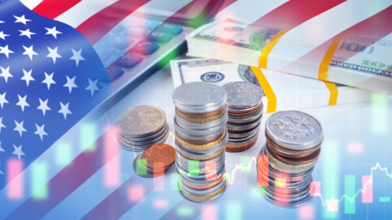 Money and calculator on table with the US flag overlaid.