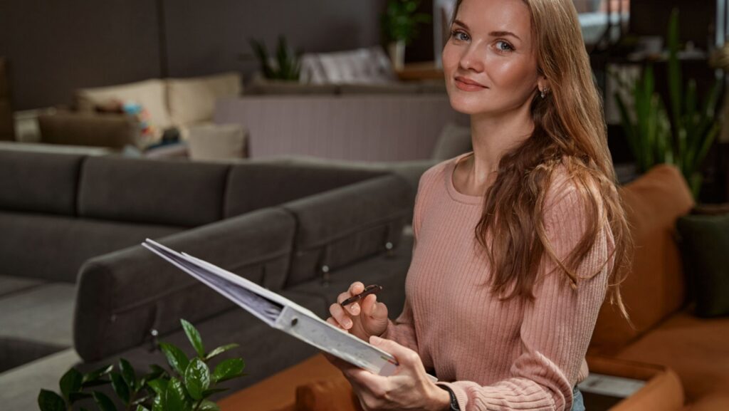 Pleased female posing for camera in furniture store