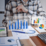 A business man in front of his computer looking at all of his business figures. Picture generated by Freepik.com