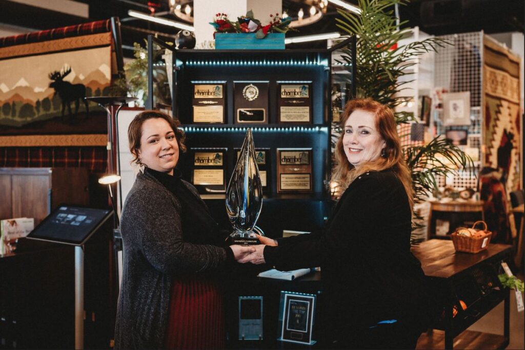 Genevieve Wilma Young and Saundra Wilma HFA Retailer of the Year holding award.