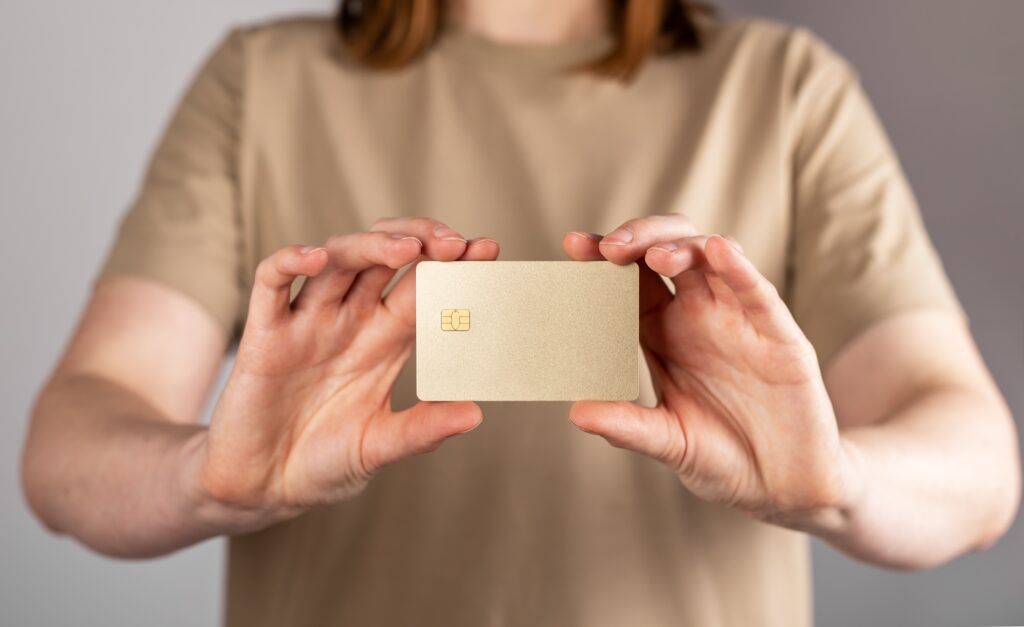 Hands holding, showing bank credit card mockup, blank gold bankcard mock up.
