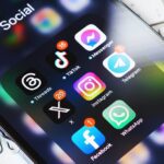 smartphone screen surrounded by other social media network apps. Twitter rebranding. Modern social media communication.