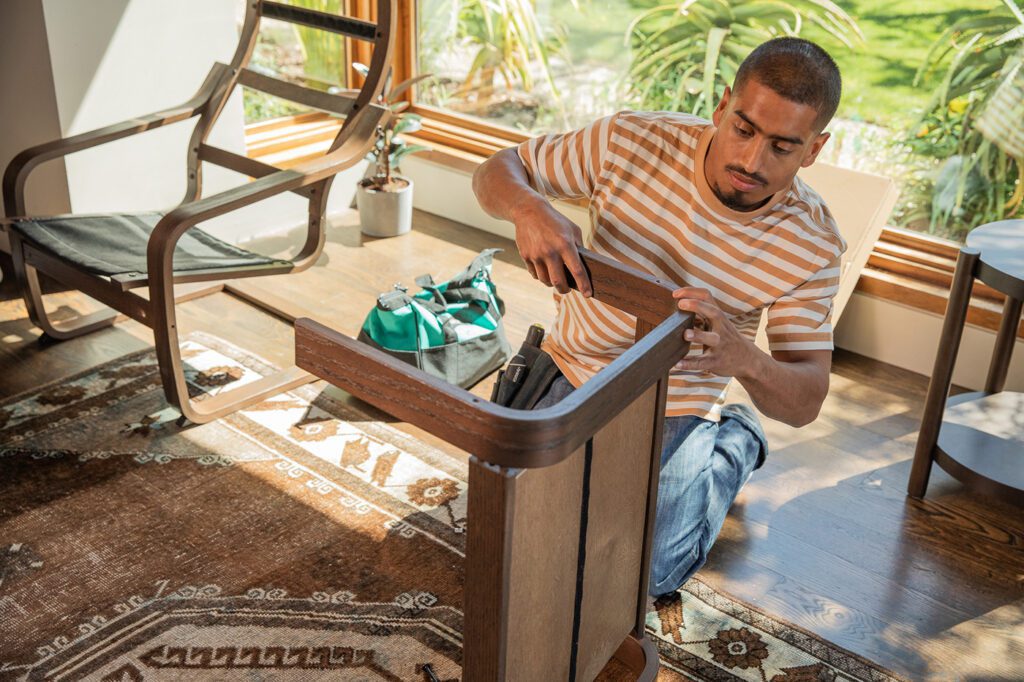 Furniture Assemblyman putting a chair together.