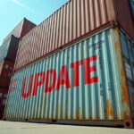 a group of import shipping containers with the word UPDATE stamped over the top.