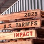 2025 U.S. Tariffs Impact, text written on piled-up pallets, supply chain management and trade concept