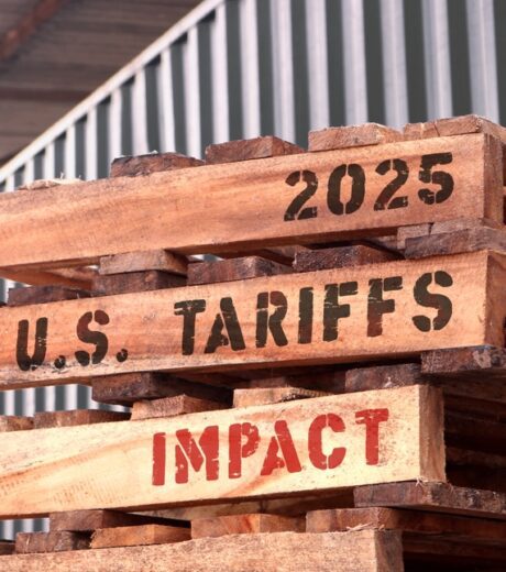 2025 U.S. Tariffs Impact, text written on piled-up pallets, supply chain management and trade concept