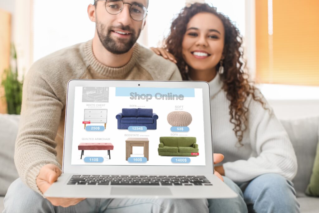 Young couple with laptop buying online new furniture at home