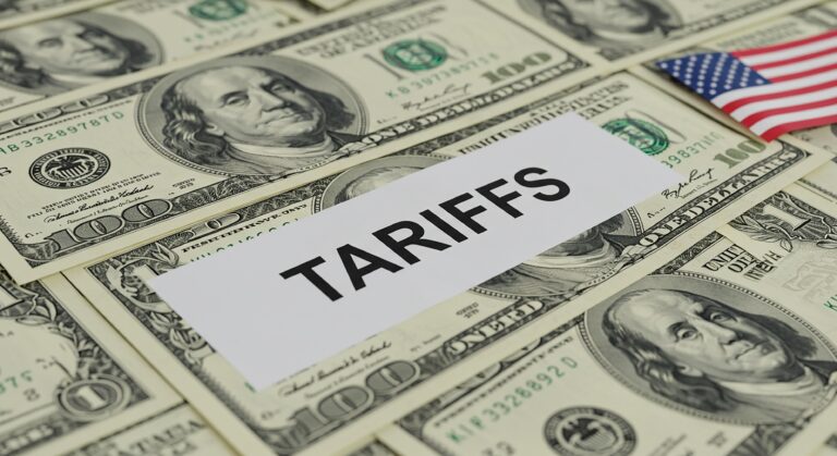 A symbolic image representing tariffs and their impact on the US economy, visualized by TARIFFS over hundreddollar bills and the American flag